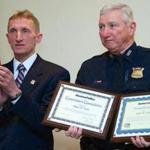 “On behalf of a grateful police department and city, thank you for your years of dedicated service,” Police Commissioner William Evans (left) said of Sergeant James “Jimmy” Earle.